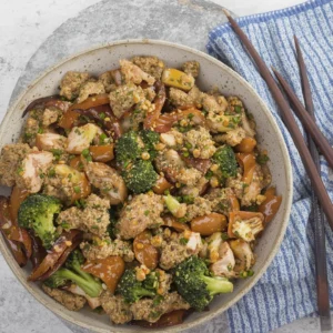 Ground chicken stir fry with broccoli, bell peppers, quinoa, and sesame seeds.
