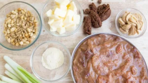 Ingredients for smothered chicken recipe including butter, peanuts, chicken broth, and seasonings ready for cooking. Perfect for a creamy and savory dish.